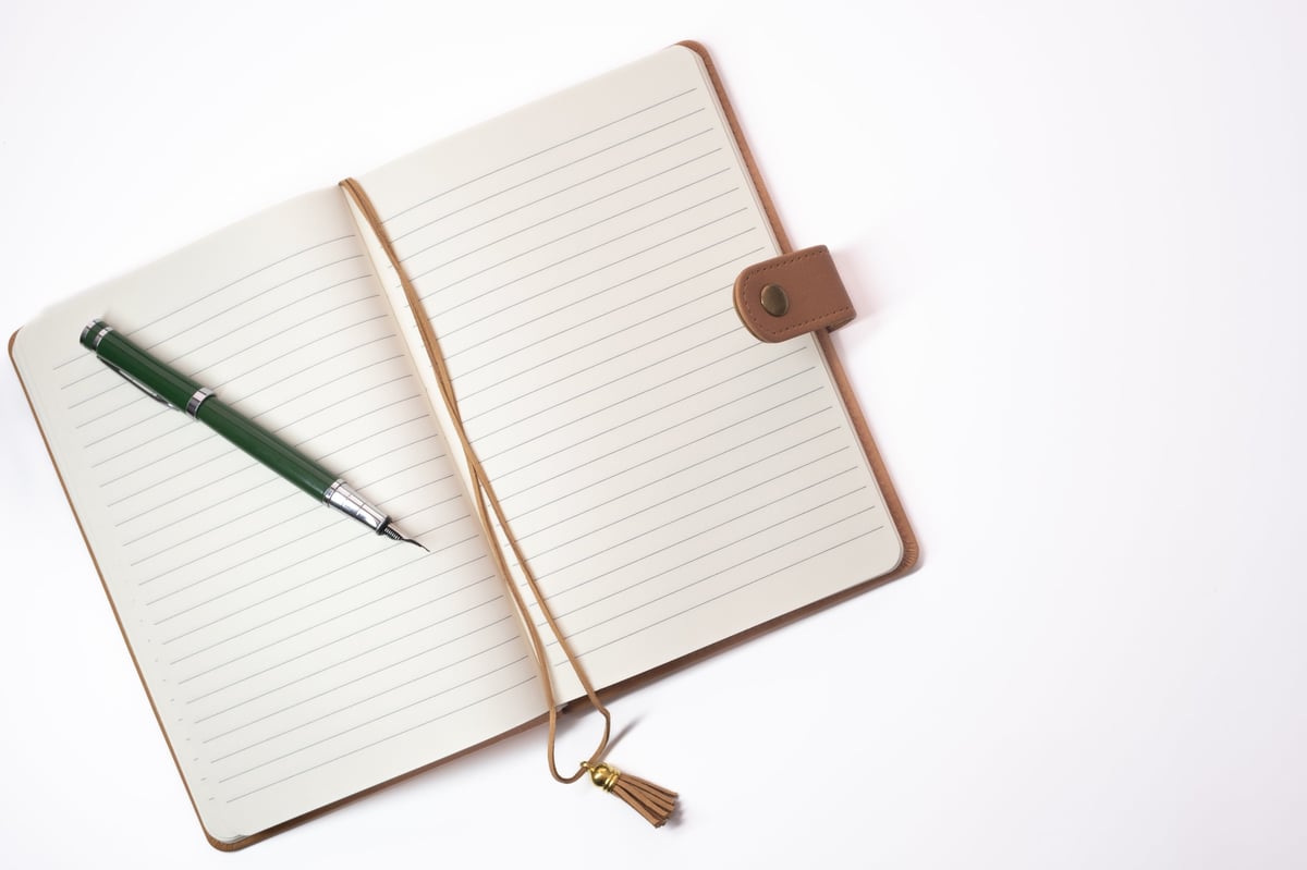 Open school notebook with a pen